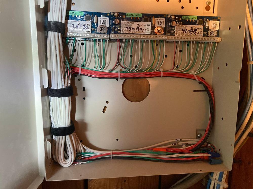 Alarm panel enclosure with cabling dressed, bundled and labelled