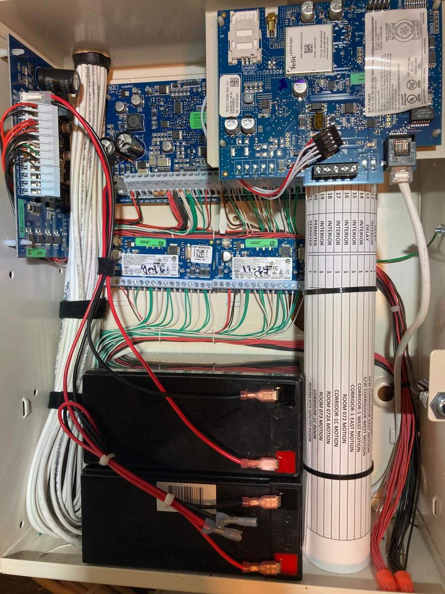 Alarm panel with zone list and battery backup, wiring dressed and tied