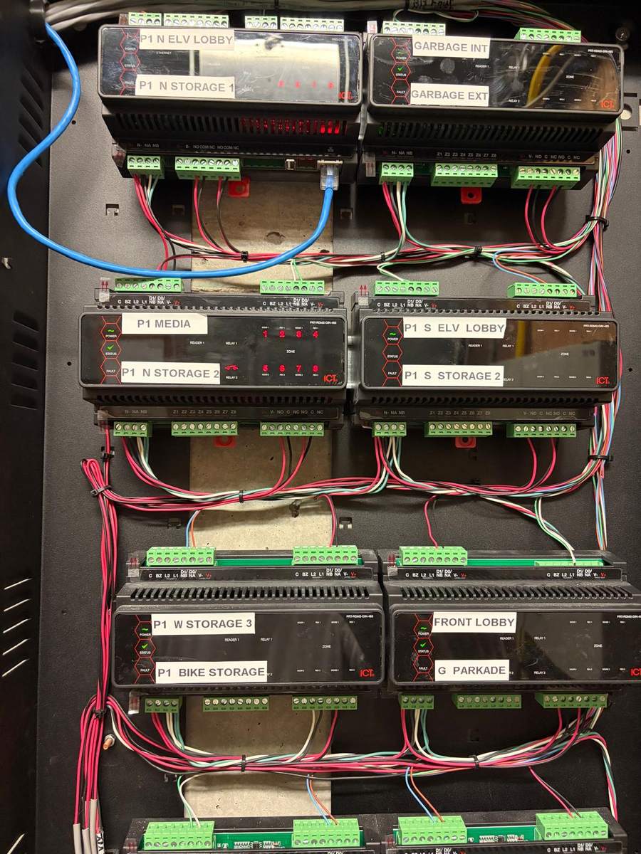 Access control modules labelled per door inside a dark equipment room