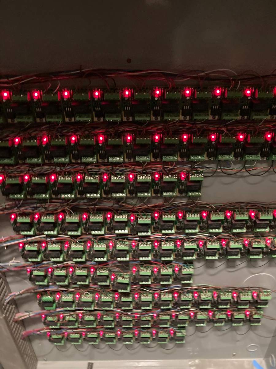 Relay modules with status indicators lit inside an equipment enclosure