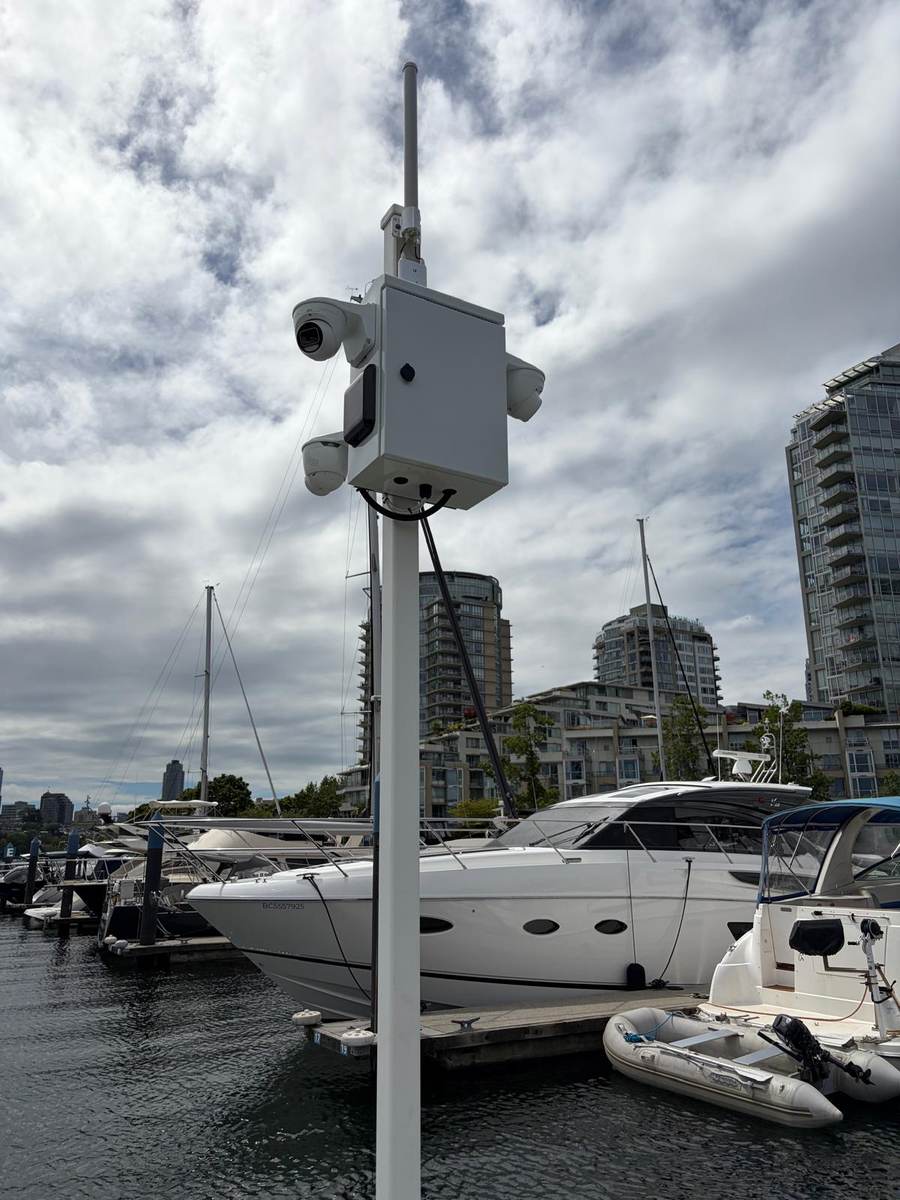 Dock-mounted camera pole overlooking moored boats at a Vancouver marina