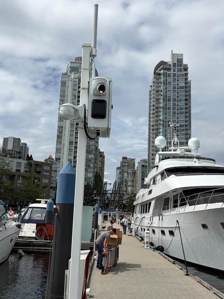 Camera and wireless bridge pole on a Coal Harbour dock beside a moored boat
